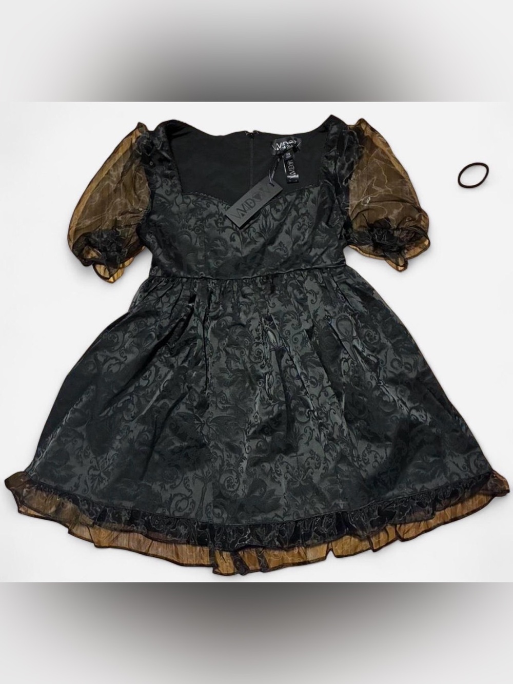 Black lace dress with sheer sleeves and bow detail